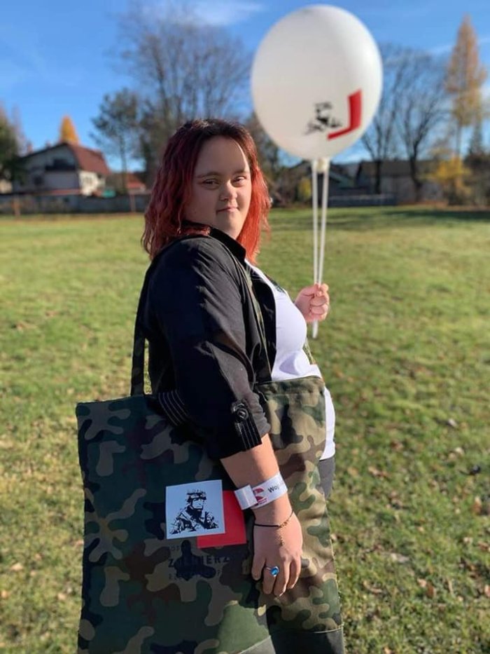 Uczennica prezentuje modę patriotyczną.